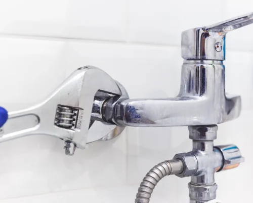 gloved-hand-tightening-plumbing-fixture-with-adjus-2026-03-19-23-08-25-utc